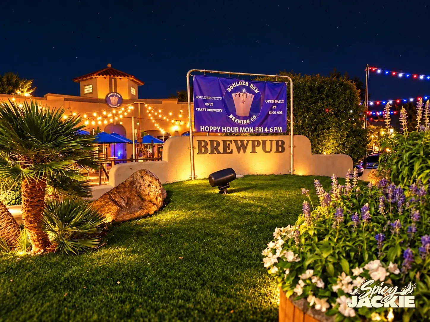 Boulder Dam Brewing’s warmly lit beer garden and brewpub beneath a clear night sky