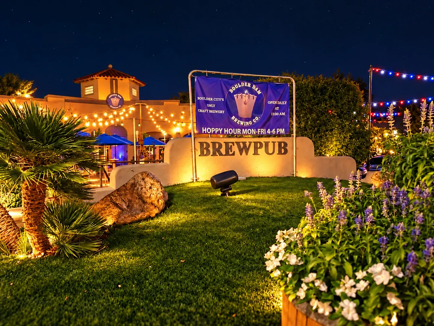 Boulder Dam Brewing’s warmly lit beer garden and brewpub beneath a clear night sky