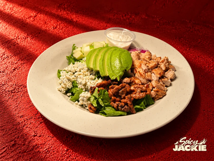 An alternative view of chicken and avocado salad with sliced apple, walnuts, and crumbled cheese