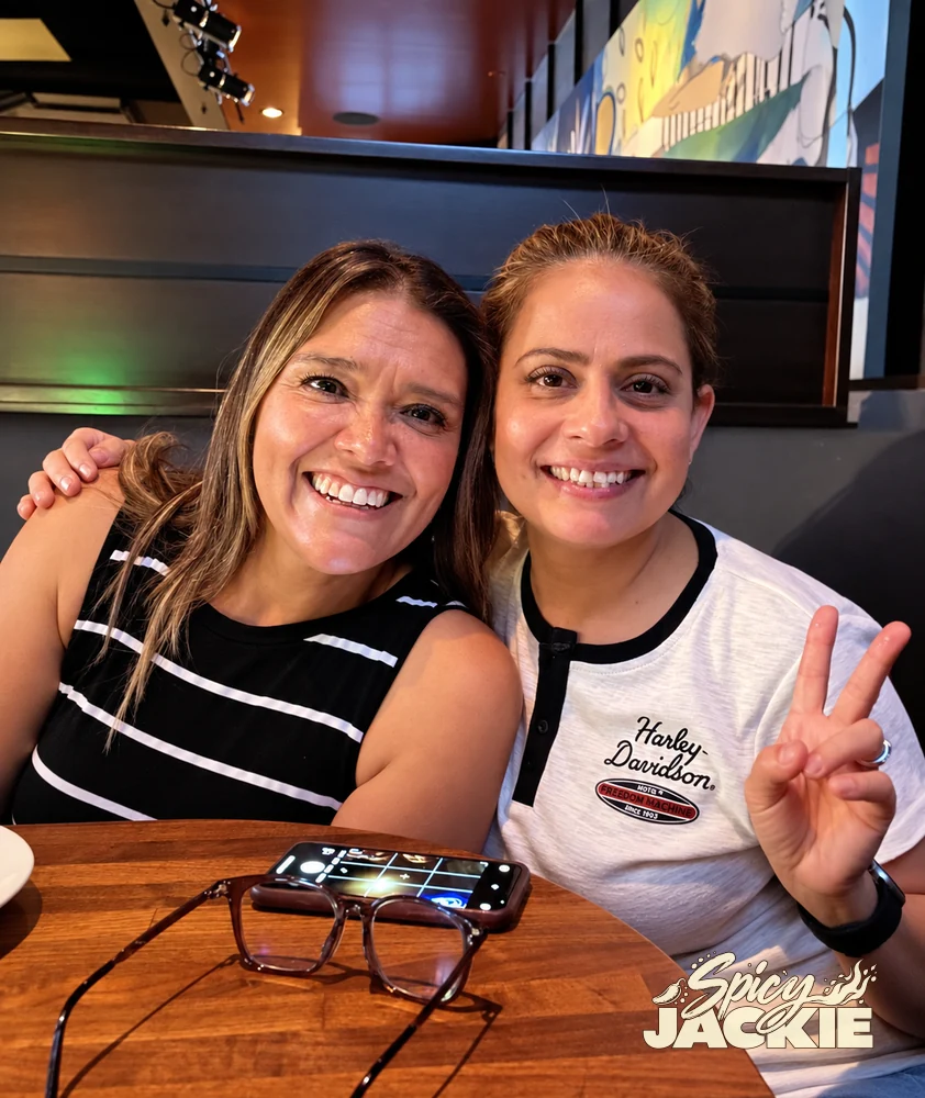 Jackie and a companion smiling together in a restaurant booth