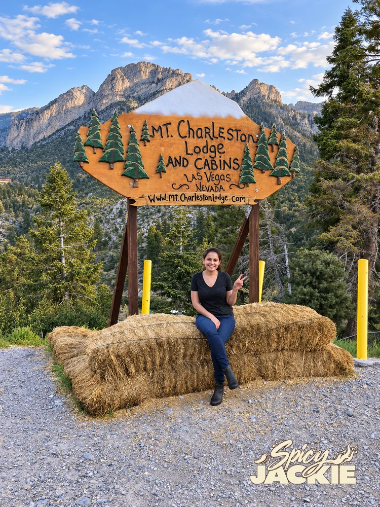 Jackie sitting on a hay bale beneath the Mt. Charleston Lodge sign