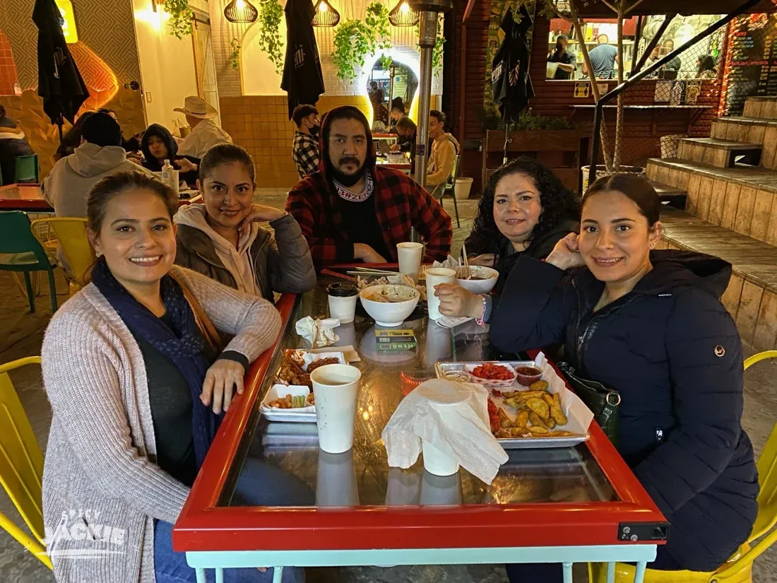 Jackie with a group of loved ones around a dining table